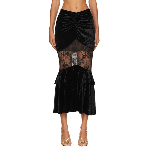 A black velvet midi skirt with a ruched waist, sheer lace panel, and ruffled hem, shown on a model against a white background.
